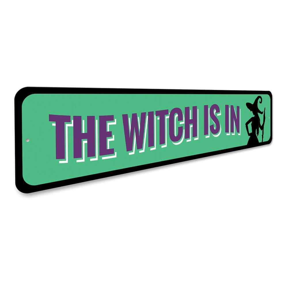 A decorative 'The Witch is IN' sign made of high-quality aluminum, featuring spooky Halloween-themed design, perfect for indoor and outdoor use.