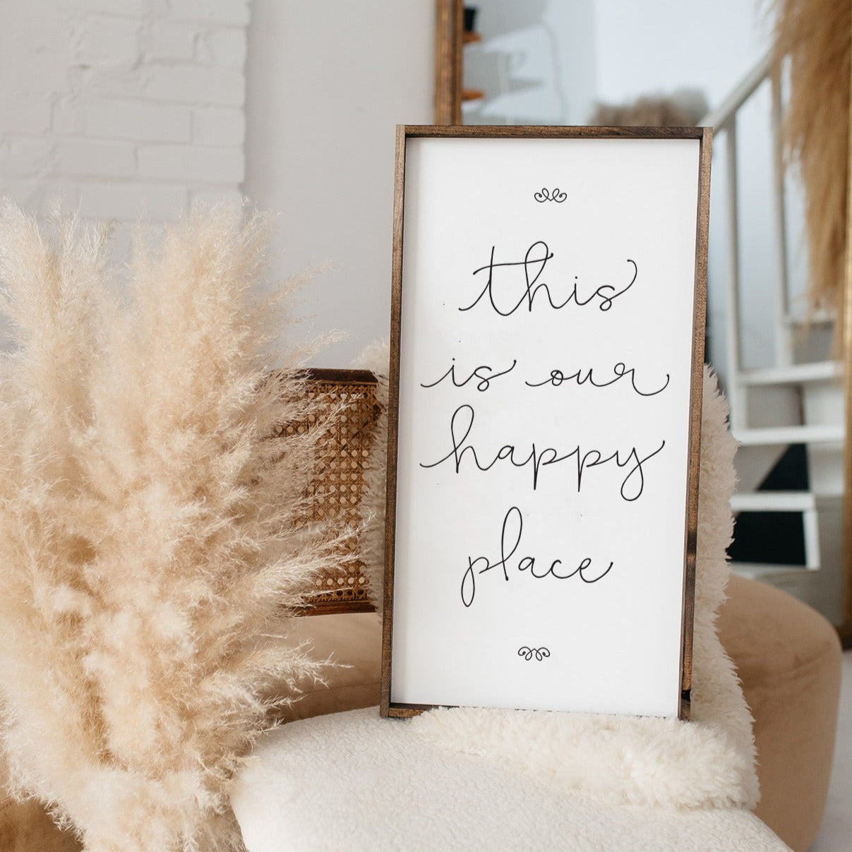 A charming wood sign reading 'This Is Our Happy Place' with a whimsical font, framed in stained pine wood, perfect for home decor.