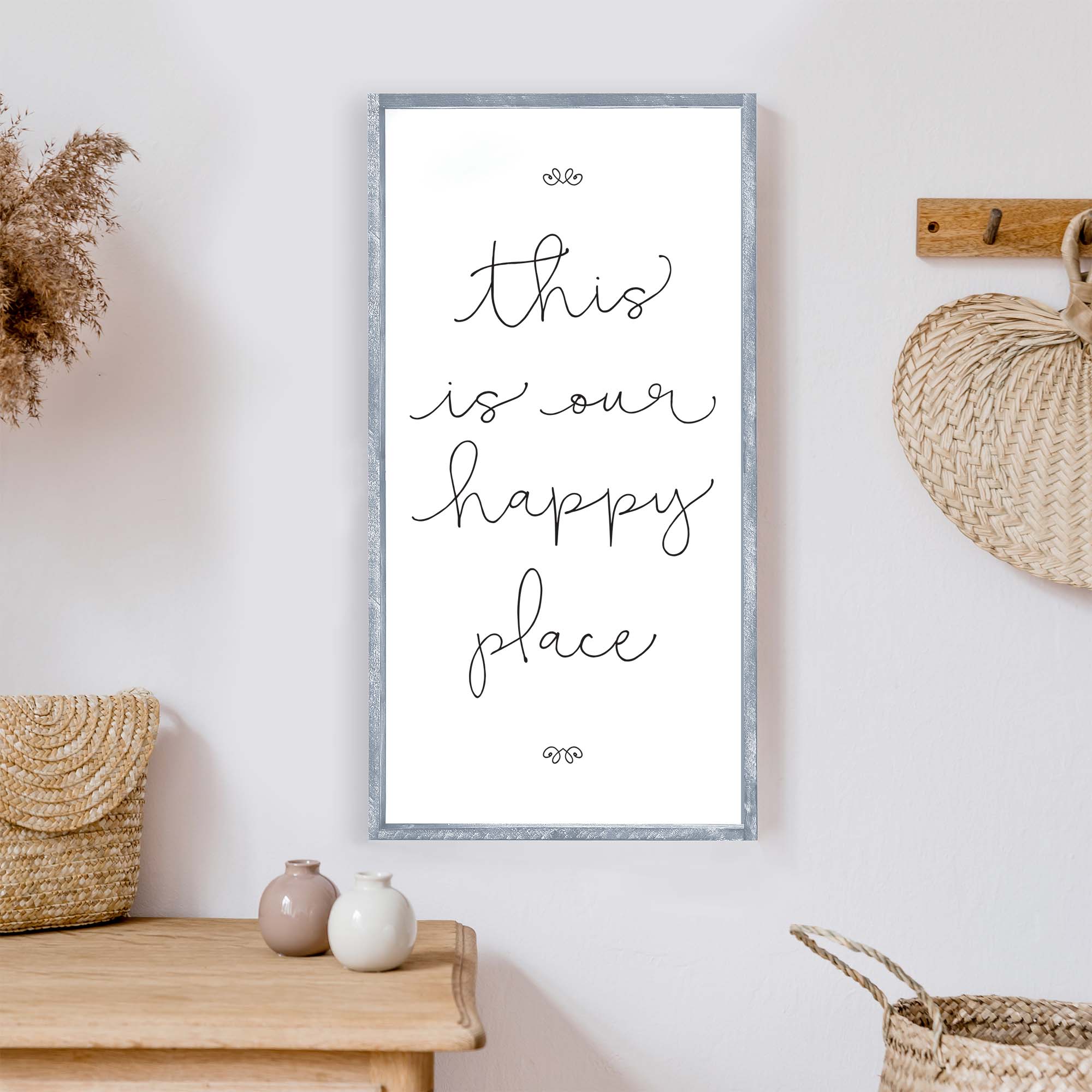 A charming wood sign reading 'This Is Our Happy Place' with a whimsical font, framed in stained pine wood, perfect for home decor.