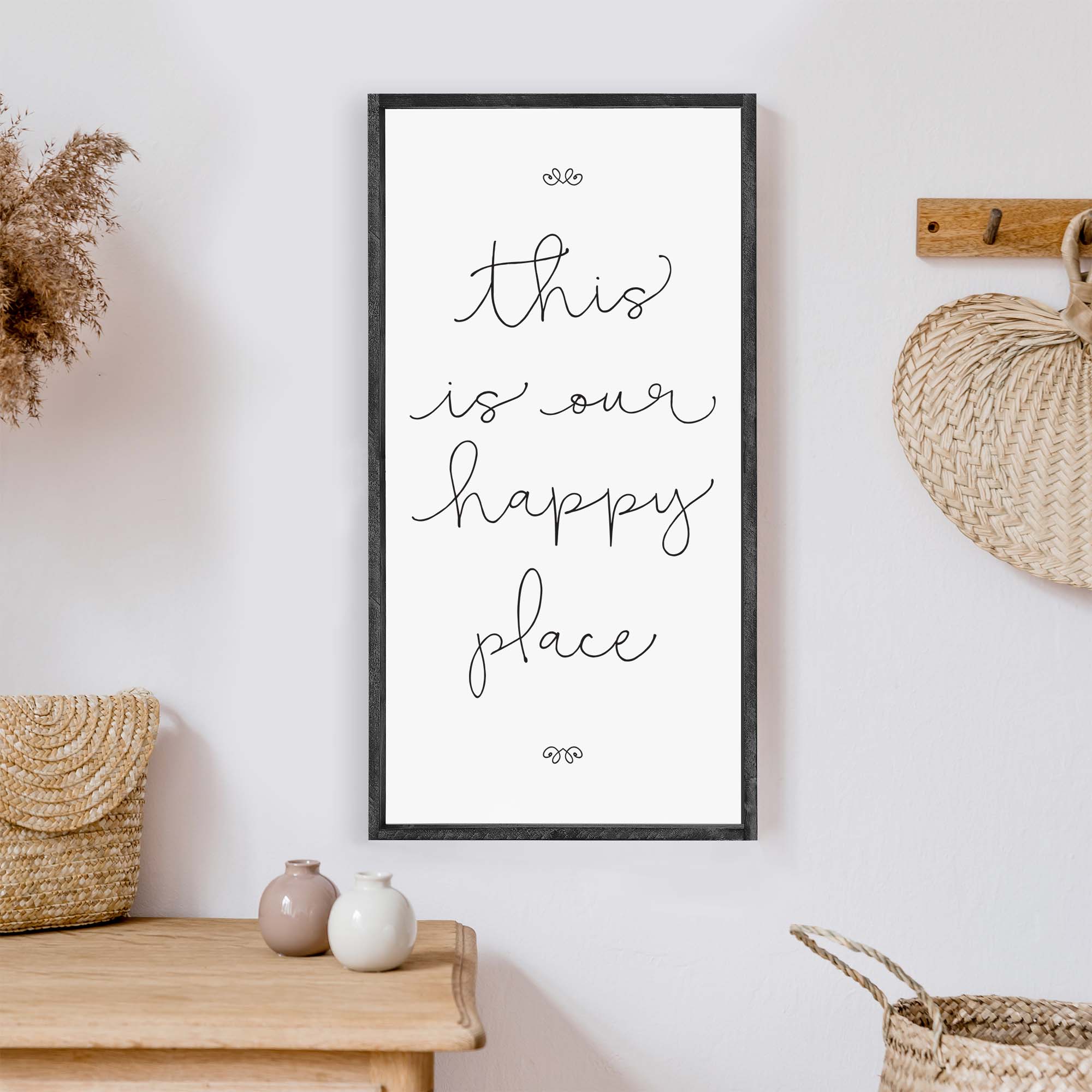 A charming wood sign reading 'This Is Our Happy Place' with a whimsical font, framed in stained pine wood, perfect for home decor.