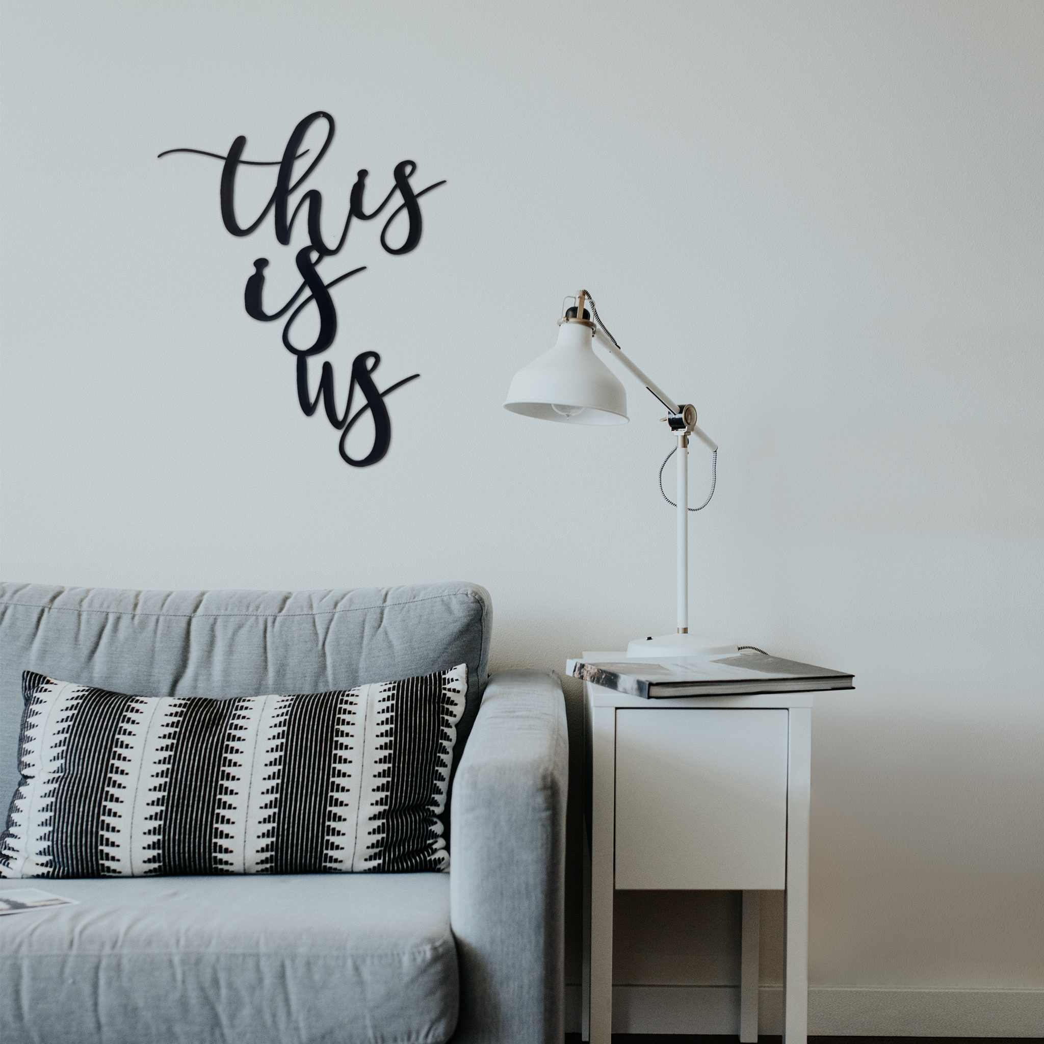This Is Us Metal Wall Art in low gloss black finish, measuring 21 inches wide and 26 inches tall, showcasing a modern design for home decor.