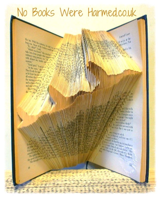 Art piece featuring three flying ducks, handcrafted from vintage book pages, showcasing unique colors and designs.