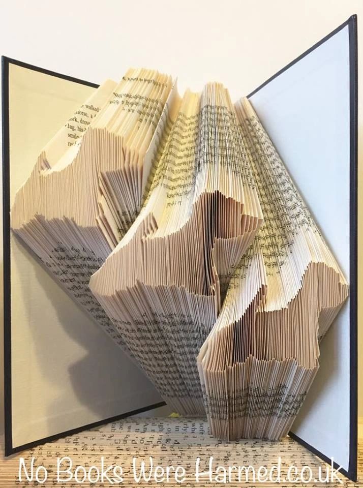 Handcrafted art piece featuring three West Highland White Terriers made from vintage book pages, showcasing intricate folds and unique textures.