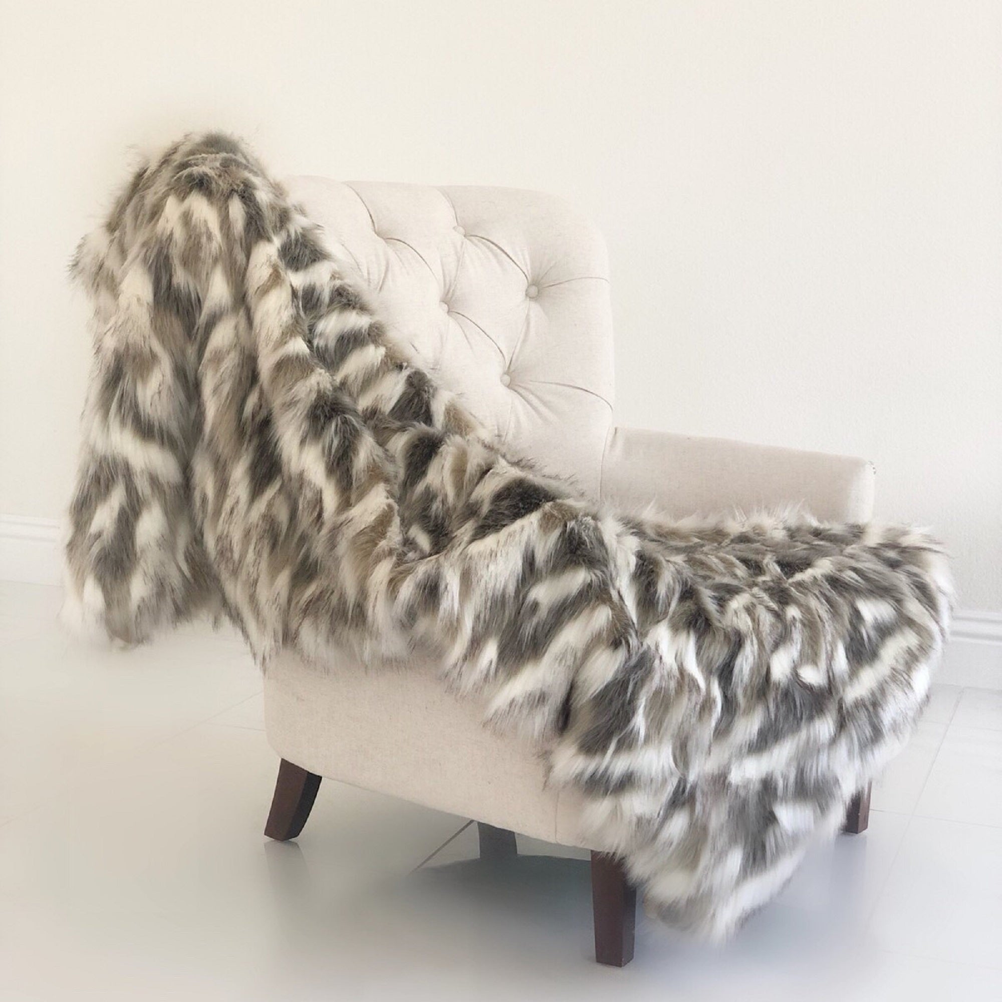 Luxurious Tibet Faux Fox Handmade Luxury Throw in ivory beige and gray, showcasing soft faux fur and microfiber backing.