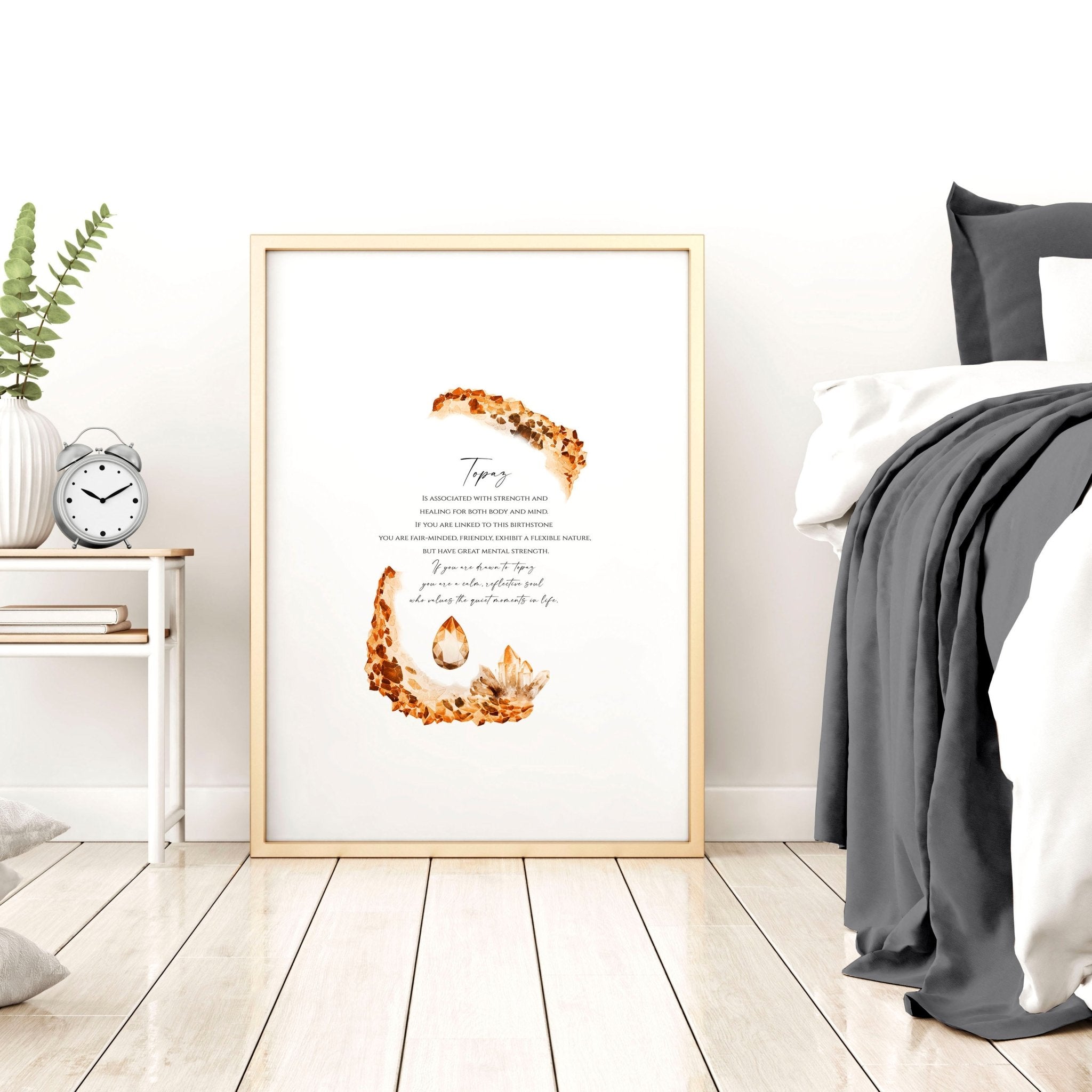 Framed wall art print featuring the Topaz birthstone in warm golden-brown hues, showcasing its shimmering facets and radiant glow.