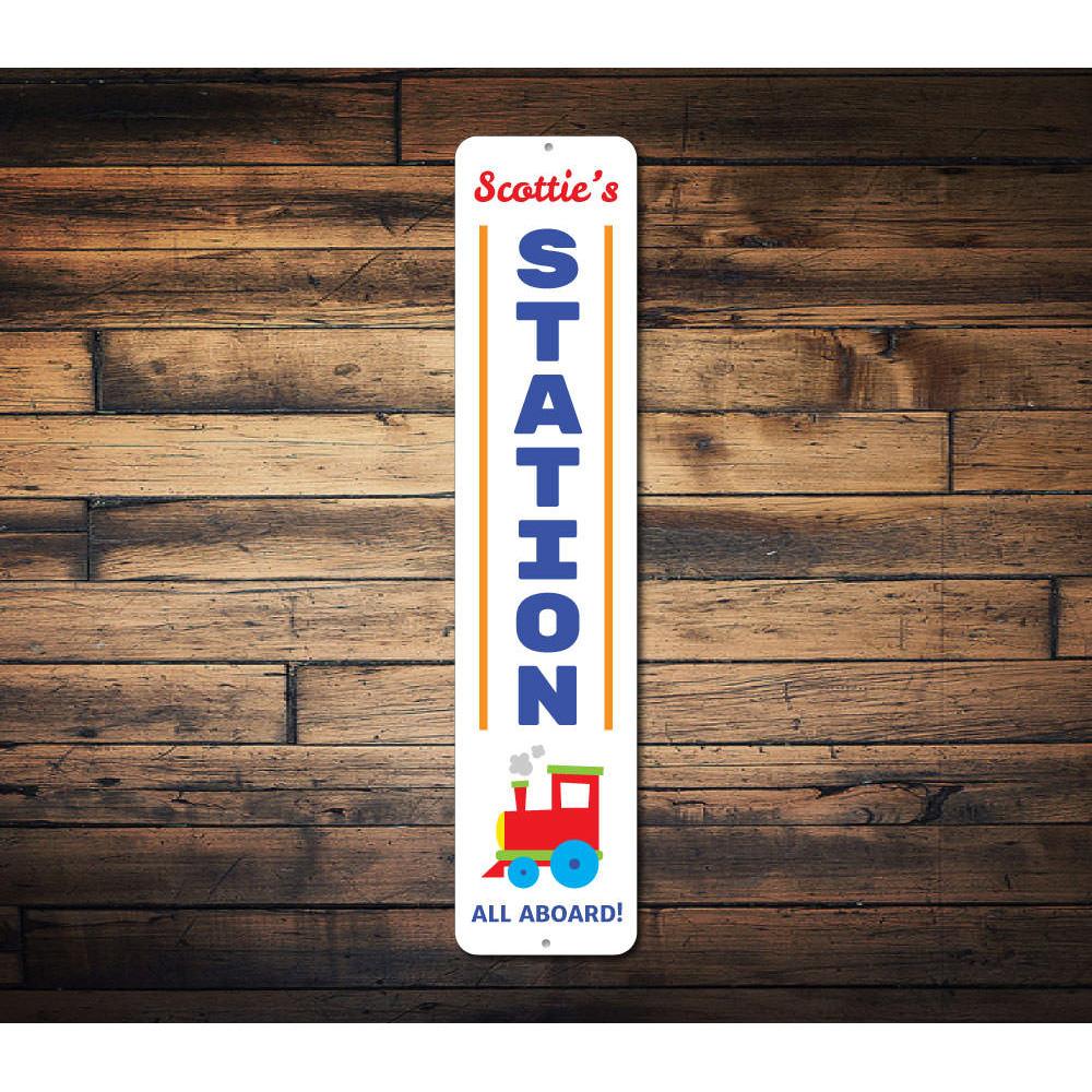 A vibrant Train Station Vertical Sign made of high-quality aluminum, featuring customizable text and pre-drilled holes for easy mounting.