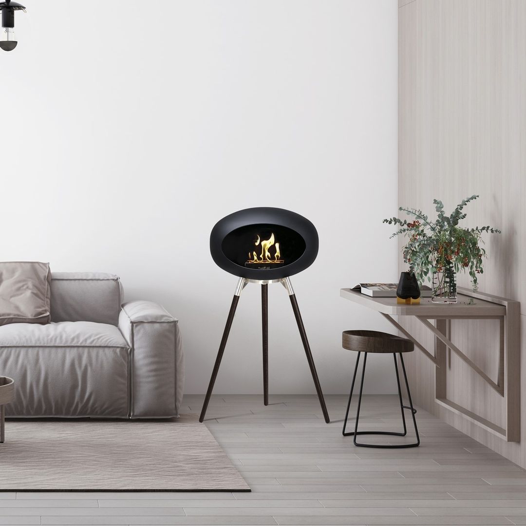 Tripod Indoor + Outdoor Ethanol Fireplace featuring wooden legs and a metal dome, providing a cozy ambiance.