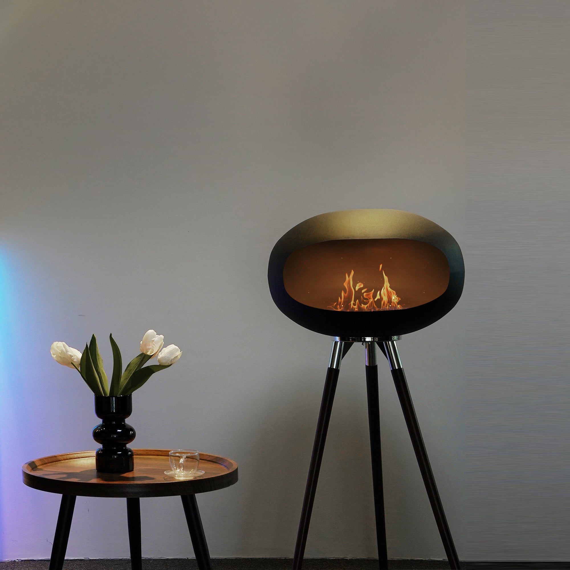 Tripod Indoor + Outdoor Ethanol Fireplace featuring wooden legs and a metal dome, providing a cozy ambiance.