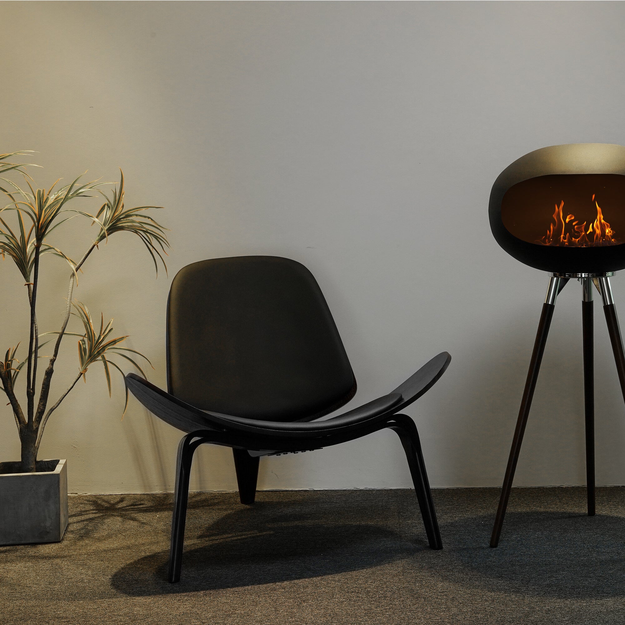 Tripod Indoor + Outdoor Ethanol Fireplace featuring wooden legs and a metal dome, providing a cozy ambiance.