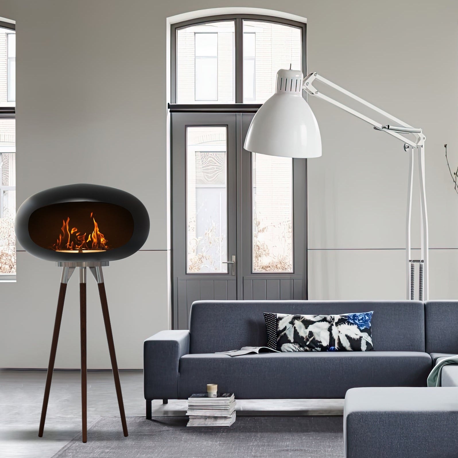 Tripod Indoor + Outdoor Ethanol Fireplace featuring wooden legs and a metal dome, providing a cozy ambiance.