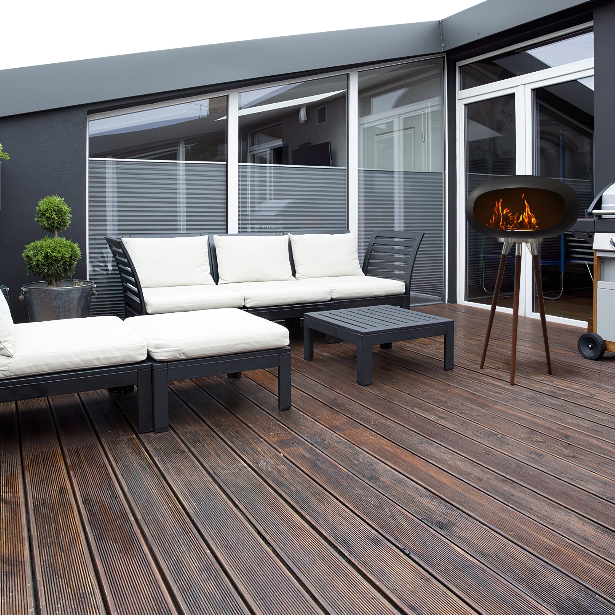 Tripod Indoor + Outdoor Ethanol Fireplace featuring wooden legs and a metal dome, providing a cozy ambiance.