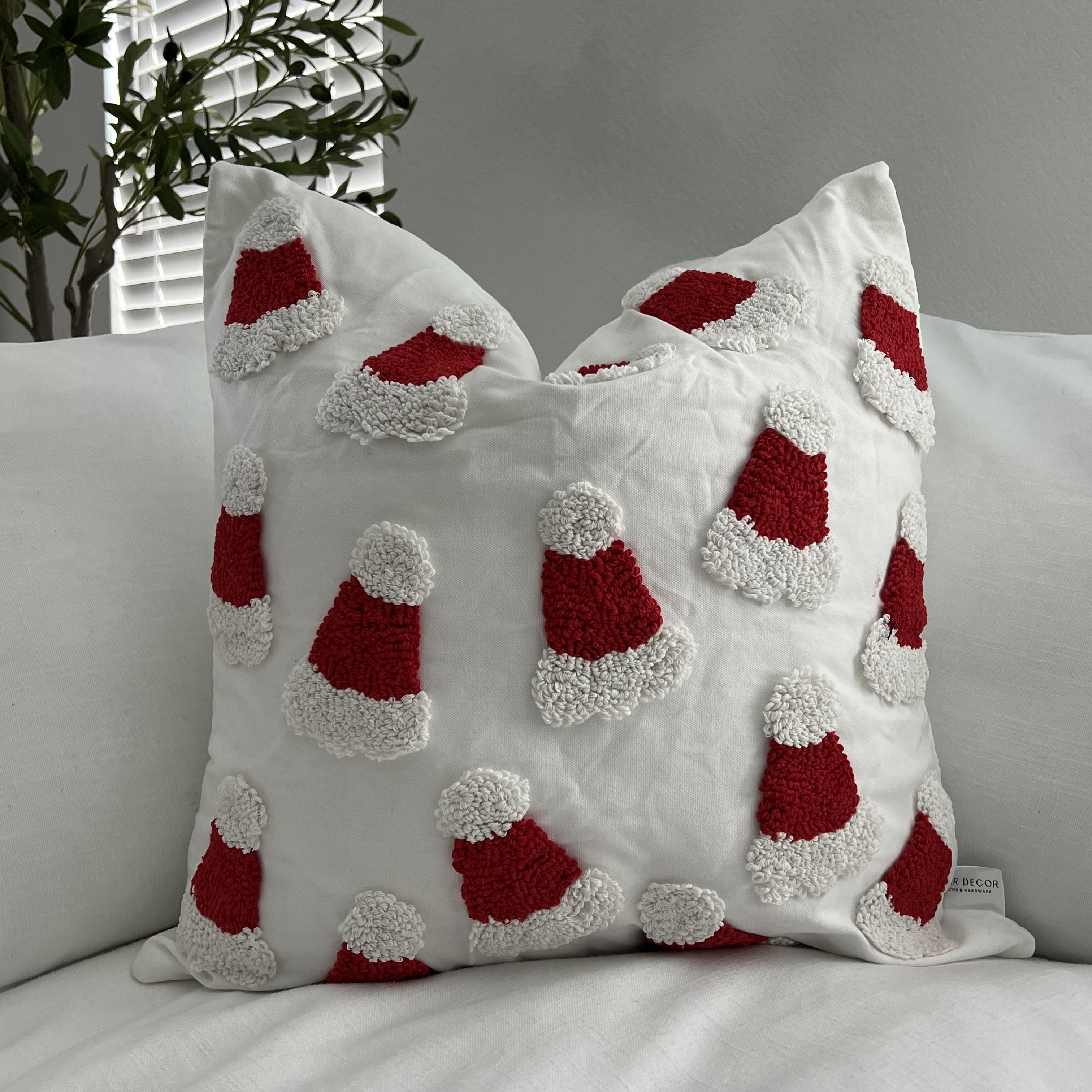 A festive 20x20 inch tufted pillow cover featuring a cheerful Santa design, perfect for holiday decor.