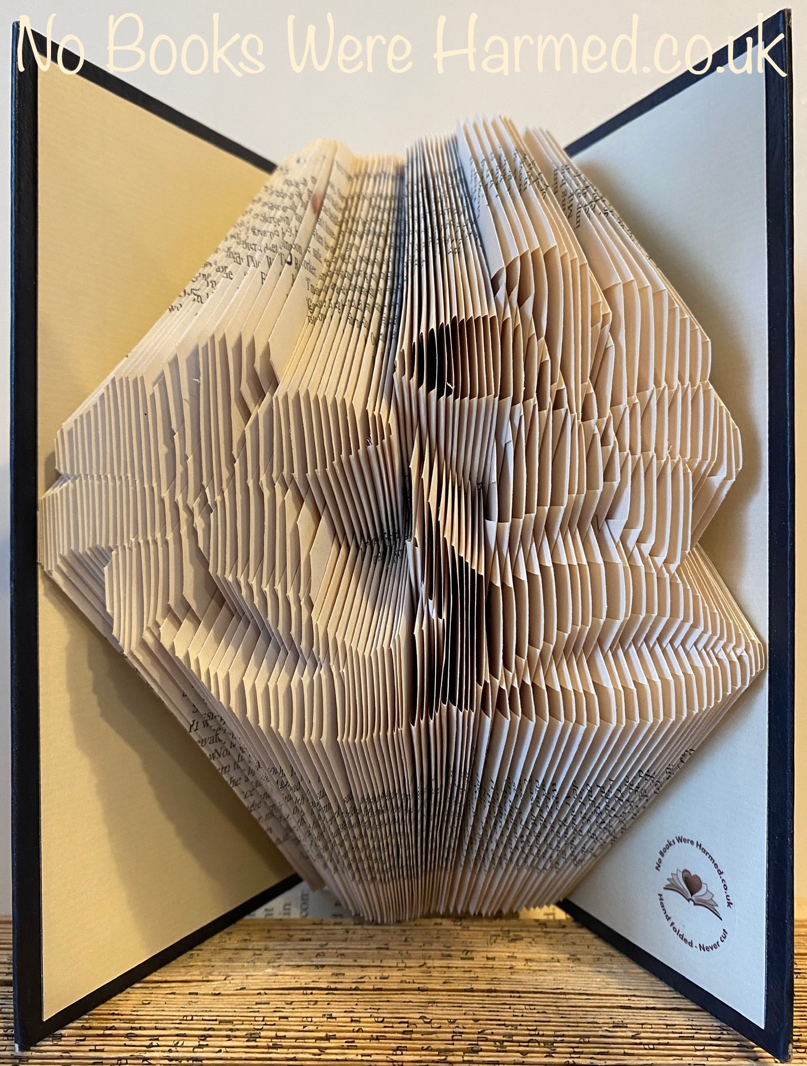 Two Lily Lillies flower book art, handcrafted from vintage book pages, showcasing intricate folds and vibrant colors.