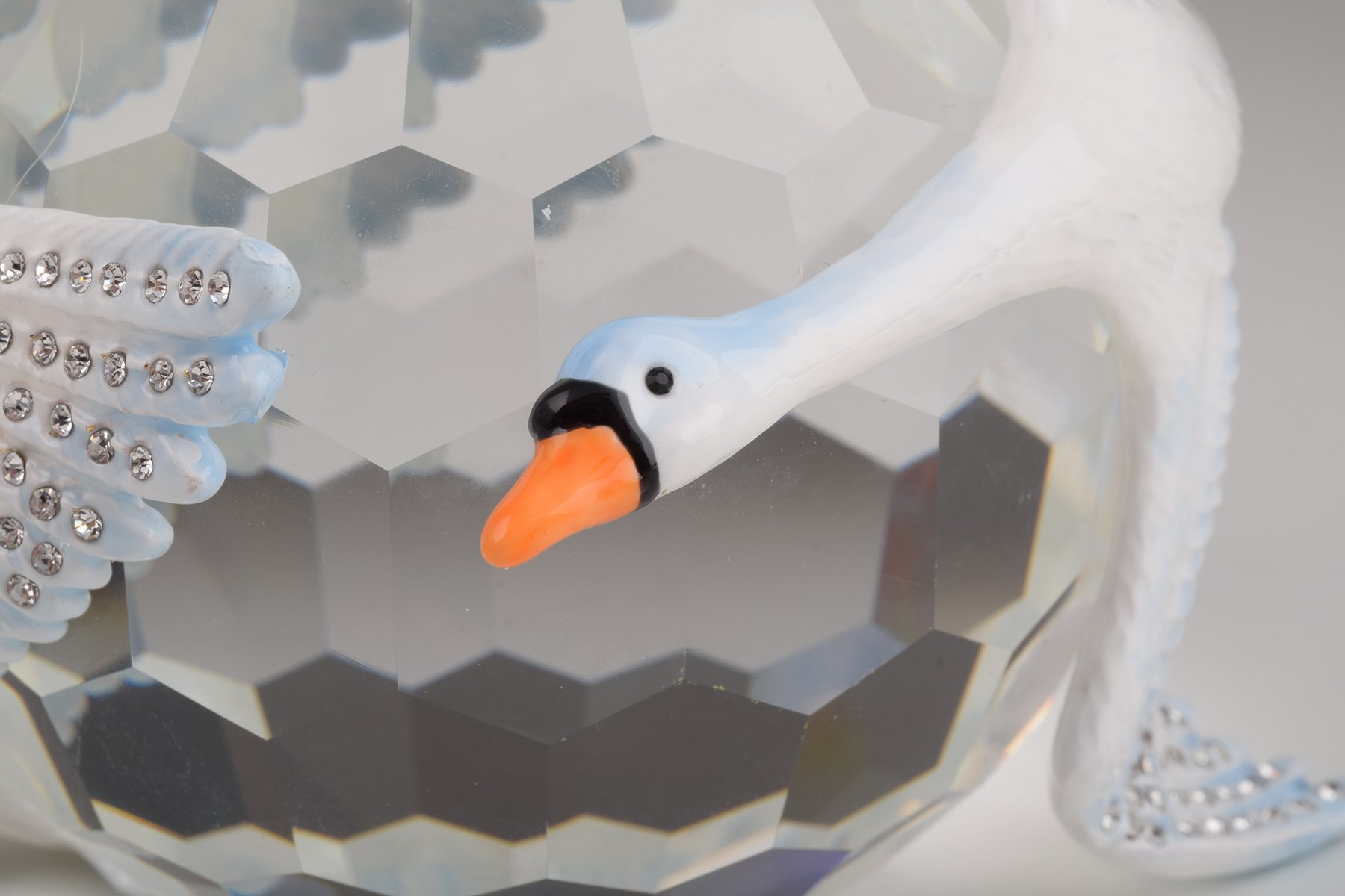 Elegant trinket box featuring two white swans on a crystal ball, adorned with Austrian crystals and plated with gold or silver.