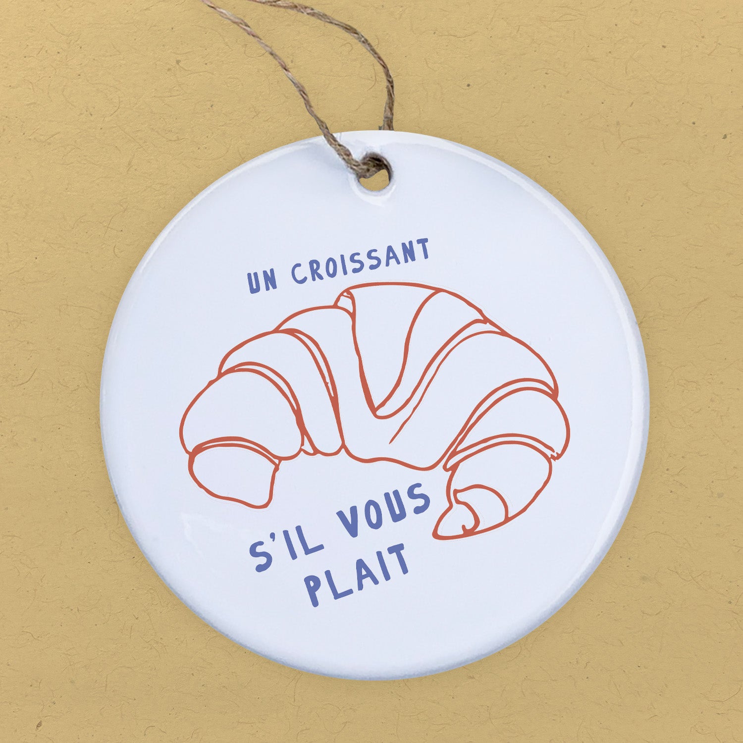 A beautifully crafted Un Croissant porcelain ornament featuring original designs, perfect for gifts and home decor.