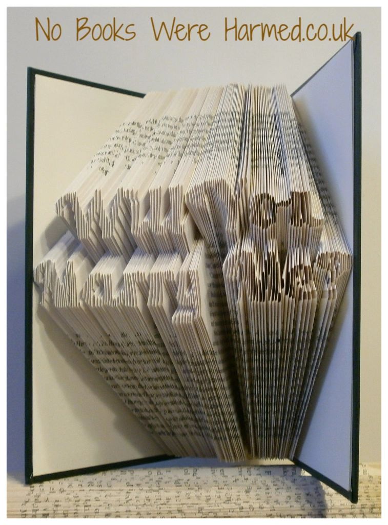 Handcrafted book art piece reading 'Will You Marry Me?' made from vintage pages, showcasing intricate folds and unique design.