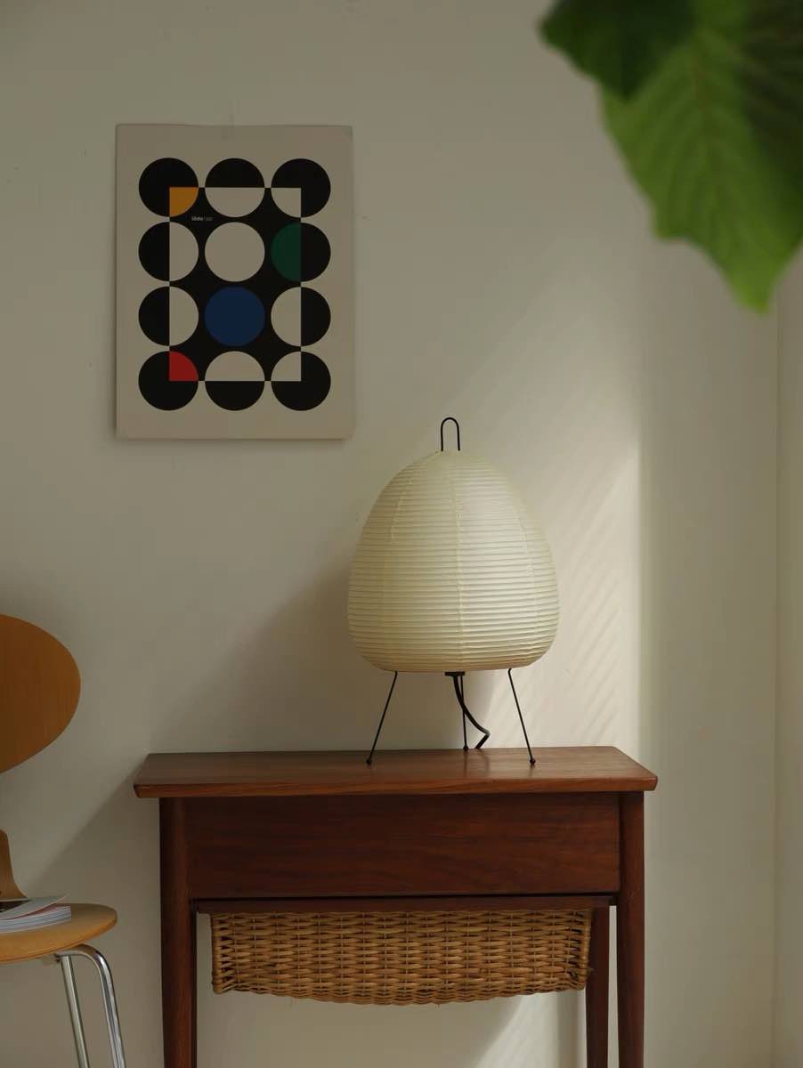 Wabi Sabi Table Lamp featuring handmade washi paper and bamboo ribbing, casting a warm glow.