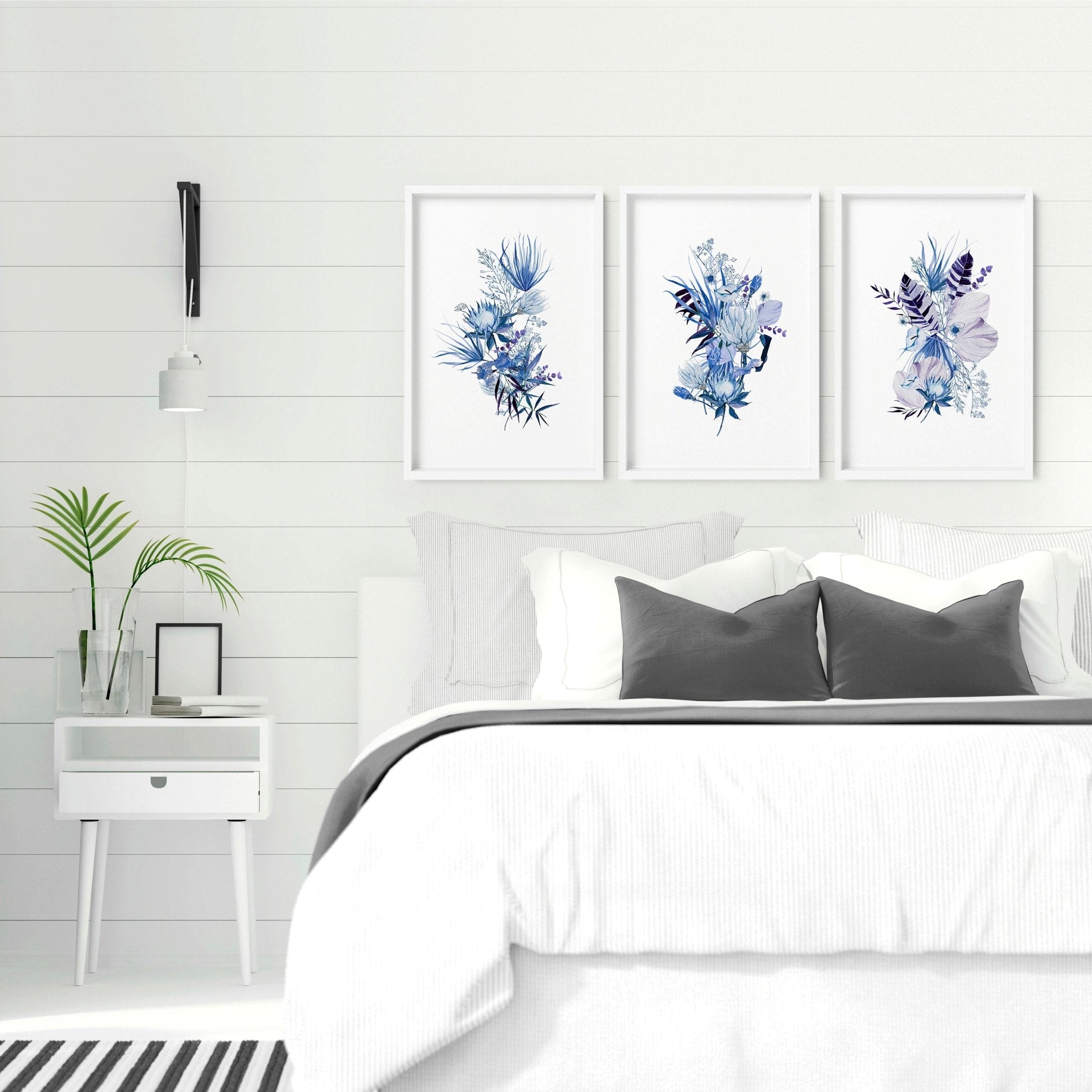 Set of three botanical wall art prints featuring rich blue and cyan colors, perfect for rustic bedroom decor.