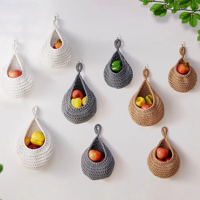 Set of three woven wall hanging fruit baskets in grey, white, and jute colors, perfect for kitchen organization.