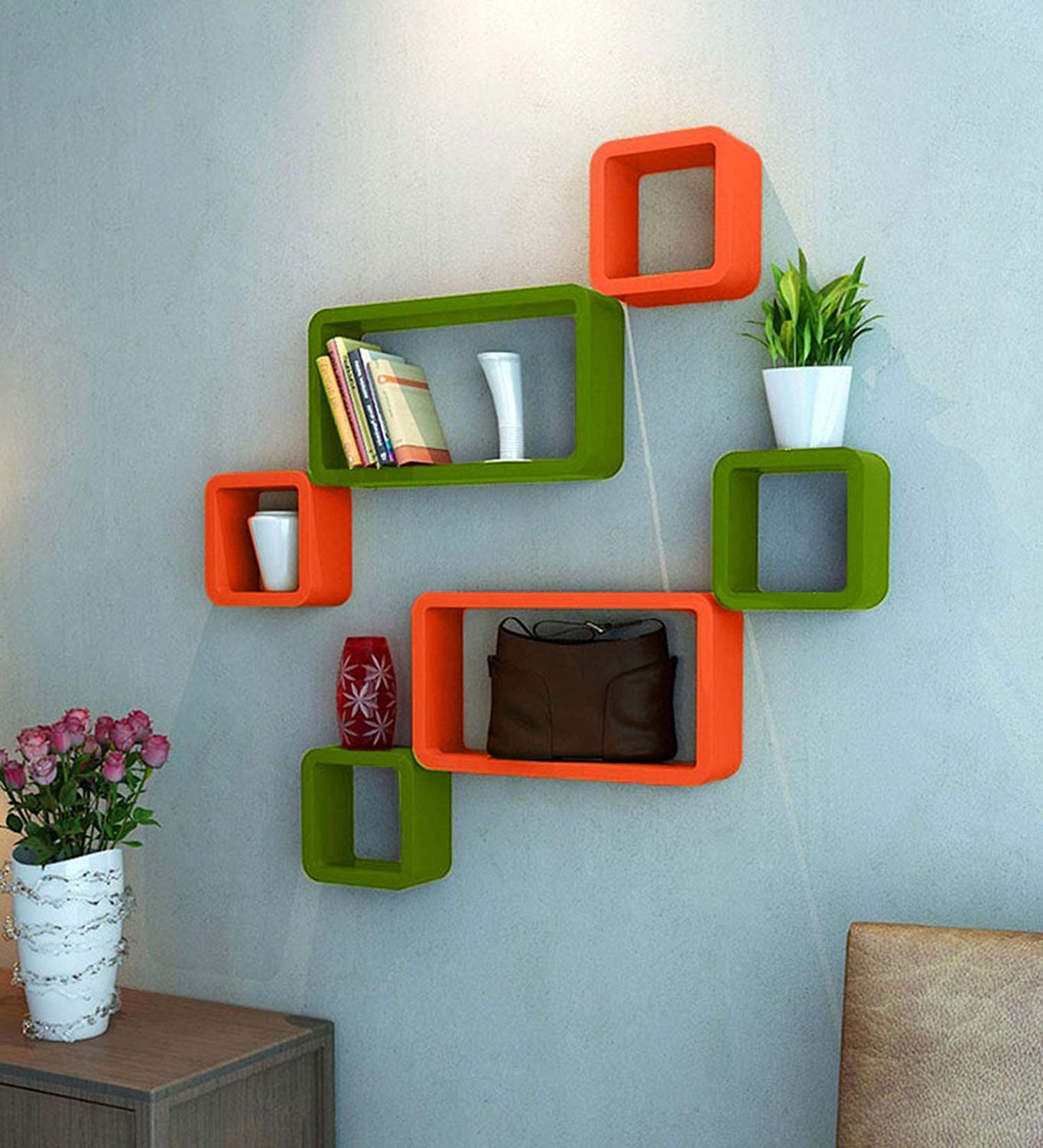 A modern 6-piece wall shelf set featuring cube and rectangle designs in vibrant green and orange, perfect for displaying books and ornaments.