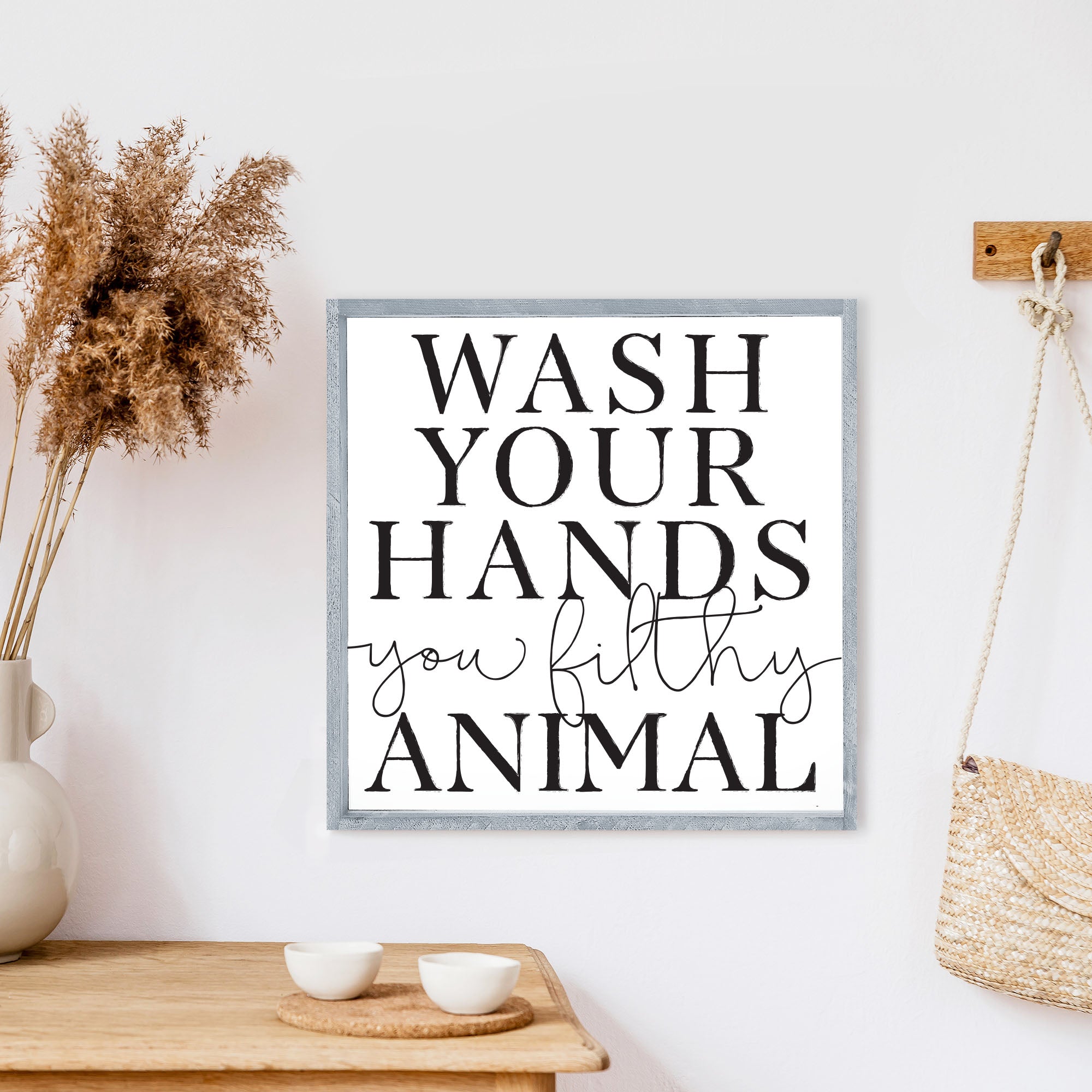 A humorous wooden sign that reads 'Wash Your Hands You Filthy Animal', featuring a rustic stained pine frame and waterproof design.