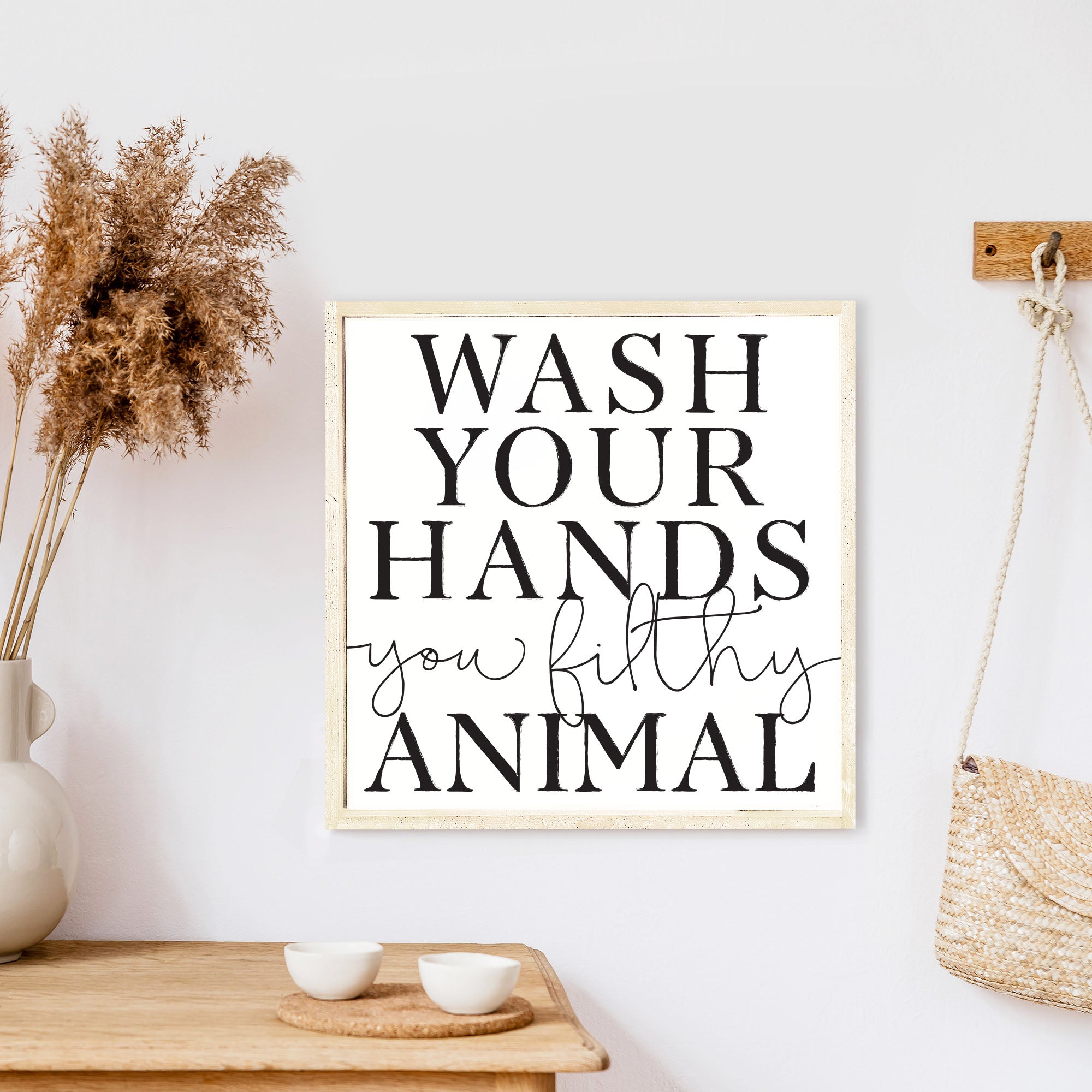 A humorous wooden sign that reads 'Wash Your Hands You Filthy Animal', featuring a rustic stained pine frame and waterproof design.