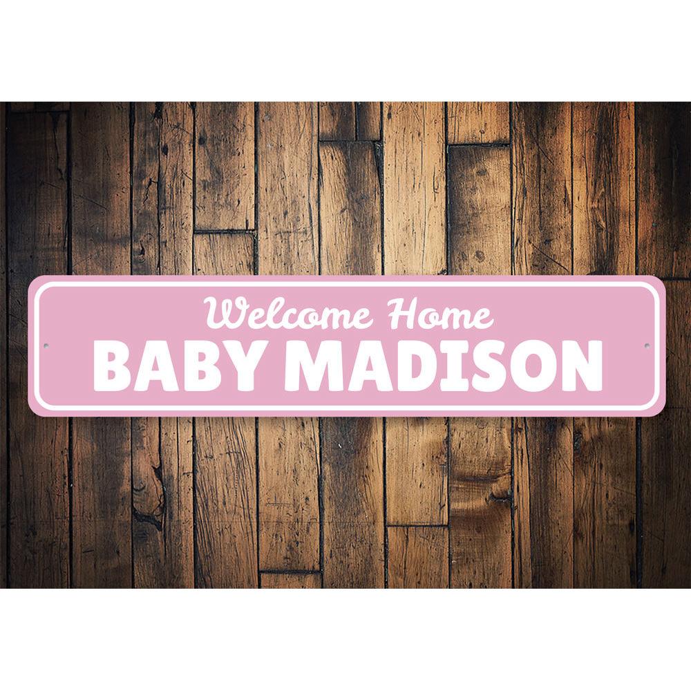 A decorative Welcome Home Baby Sign made of high-quality aluminum, featuring customizable text and pre-drilled holes for easy mounting.