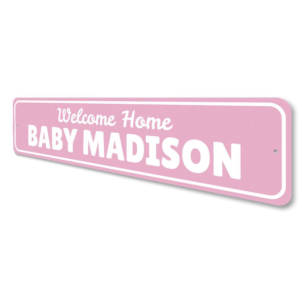 A decorative Welcome Home Baby Sign made of high-quality aluminum, featuring customizable text and pre-drilled holes for easy mounting.
