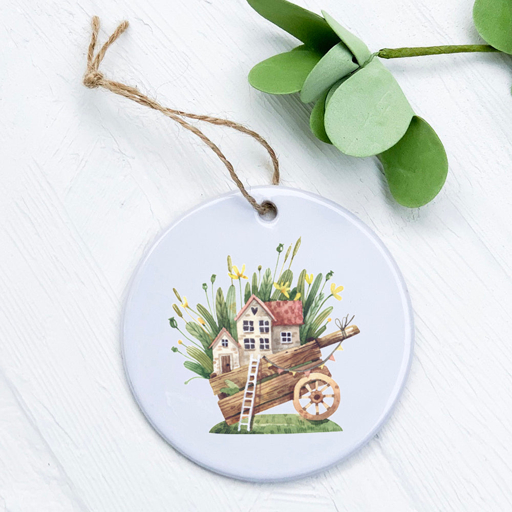 A beautifully crafted porcelain Wheelbarrow Fairy House ornament featuring vibrant colors and intricate details, perfect for home decor.