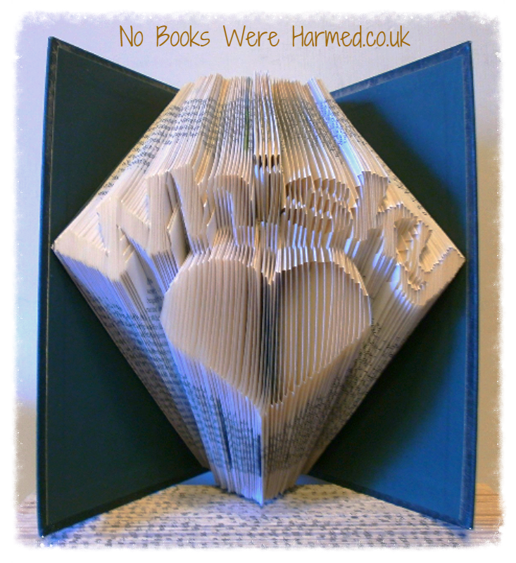 A handcrafted Whisky Heart art piece made from vintage book pages, showcasing intricate folds and unique design.