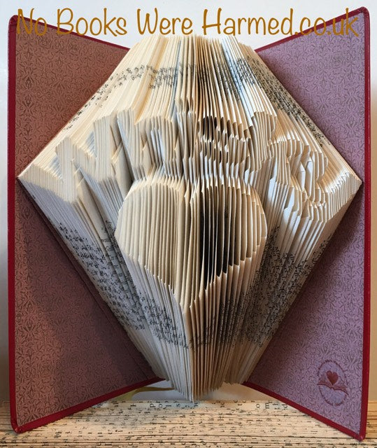 A handcrafted Whisky Heart art piece made from vintage book pages, showcasing intricate folds and unique design.