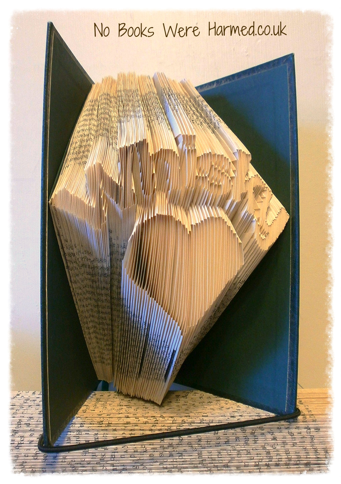 A handcrafted Whisky Heart art piece made from vintage book pages, showcasing intricate folds and unique design.