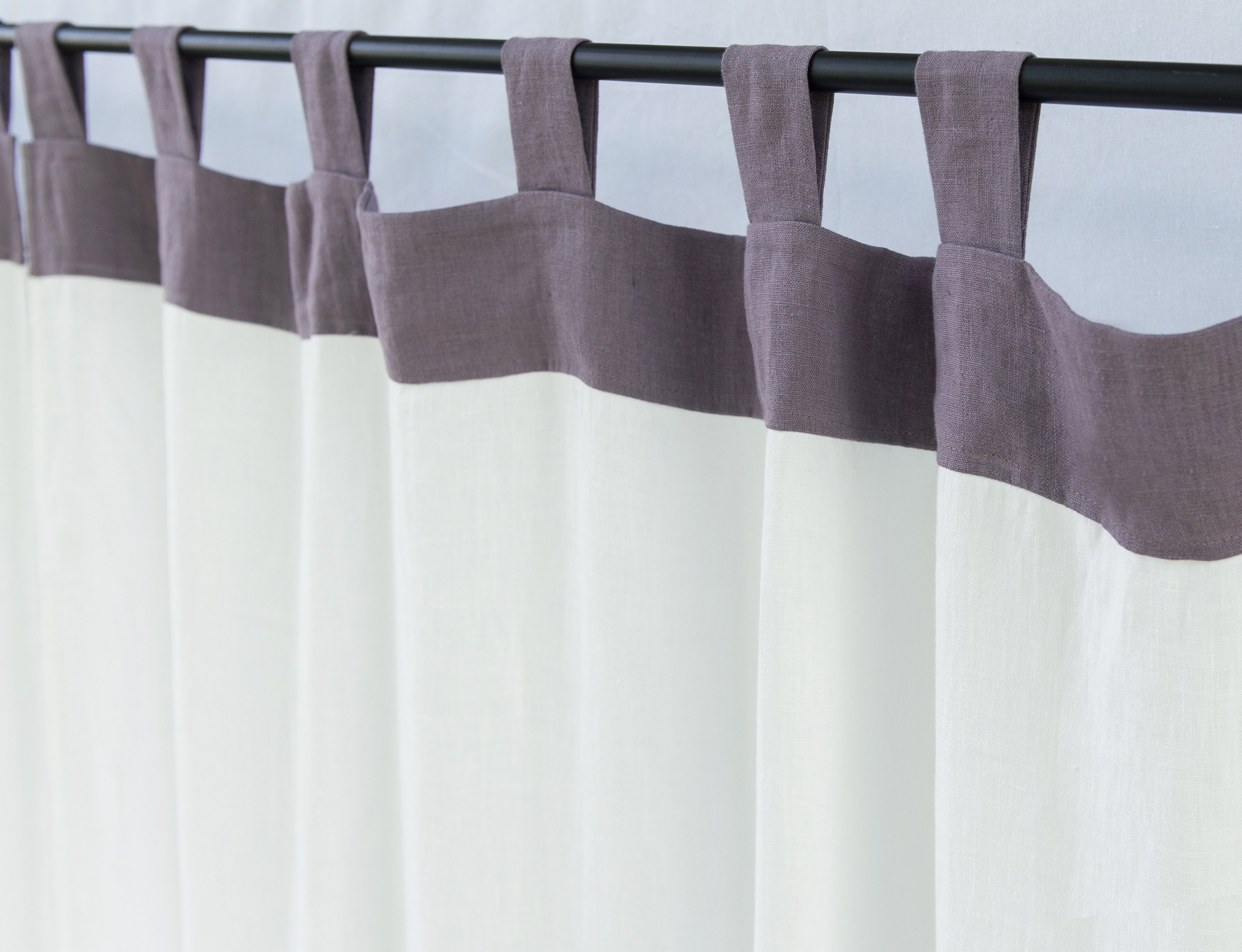 Elegant White and Pastel Plum linen curtains with tab tops, showcasing a modern two-tone design.