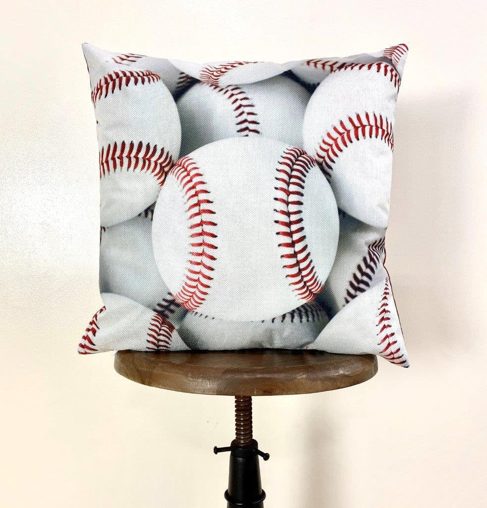 A collection of White Baseballs pillow covers featuring vibrant baseball graphics on the front and a solid red back, showcasing quality craftsmanship.