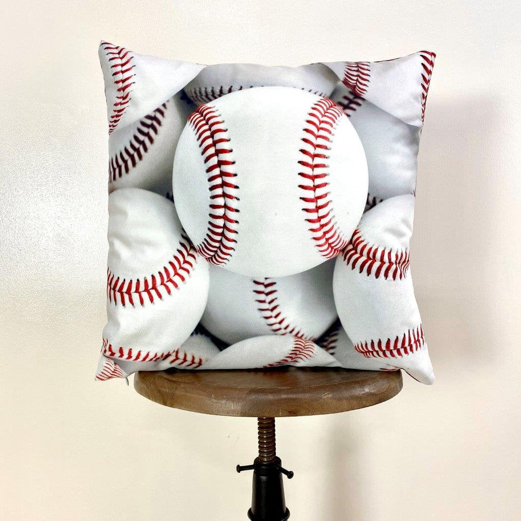 A collection of White Baseballs pillow covers featuring vibrant baseball graphics on the front and a solid red back, showcasing quality craftsmanship.