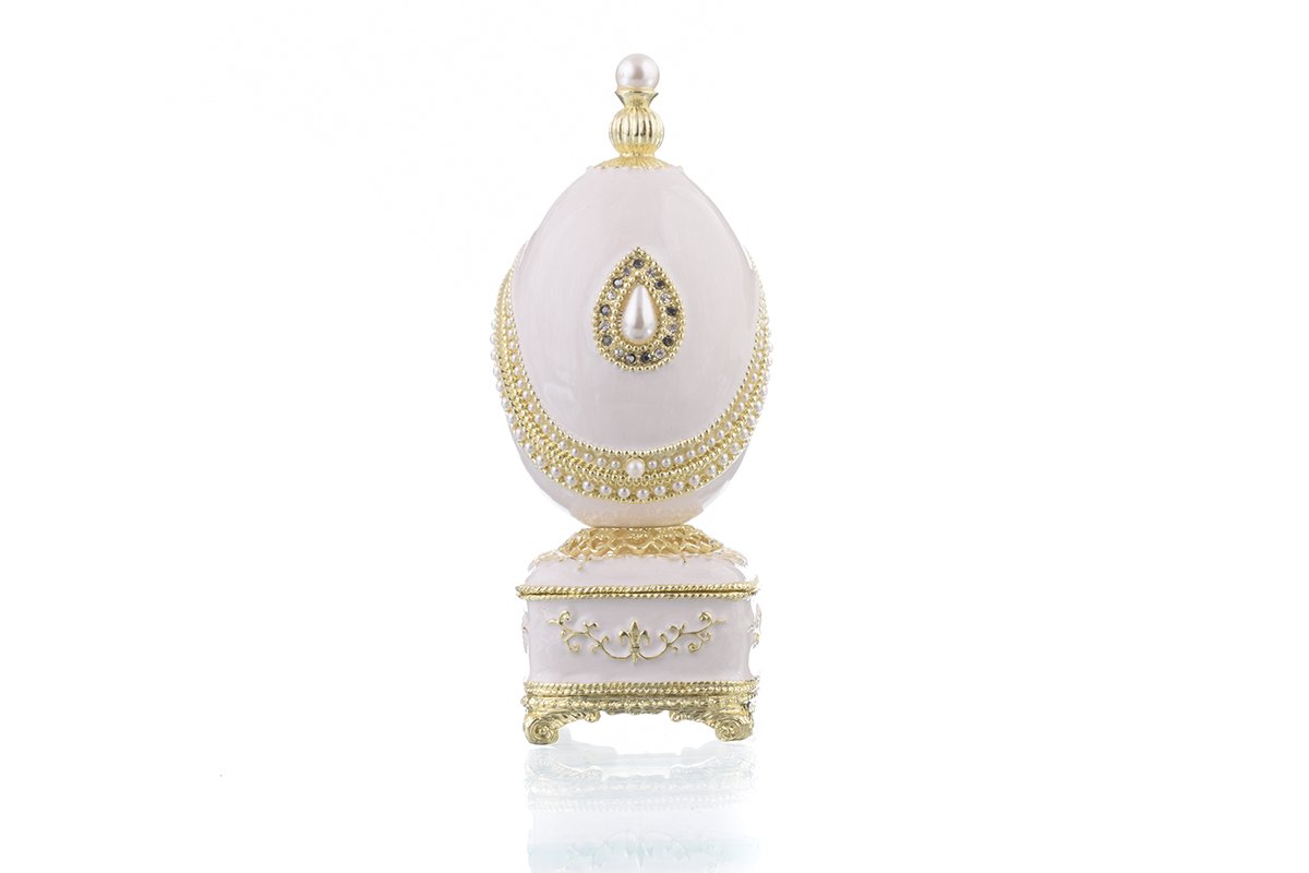A beautifully crafted White Faberge Egg trinket box adorned with Austrian crystals and a pearl, showcasing intricate enamel painting and luxurious gold or silver plating.