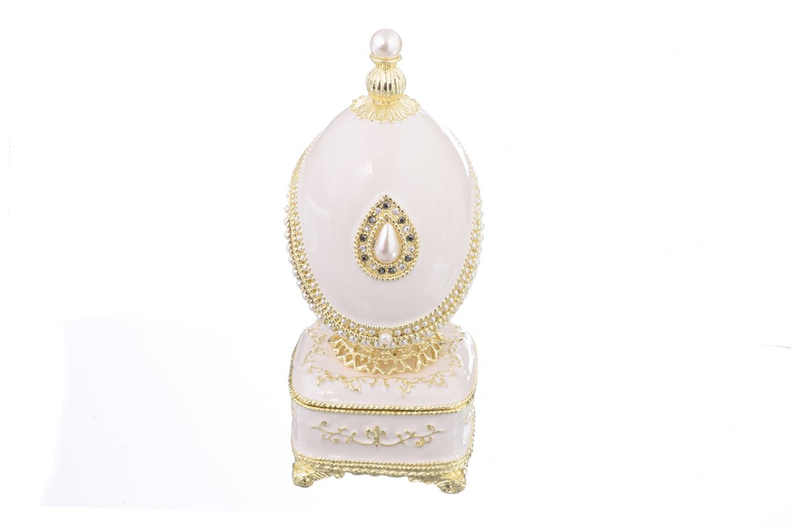 A beautifully crafted White Faberge Egg trinket box adorned with Austrian crystals and a pearl, showcasing intricate enamel painting and luxurious gold or silver plating.