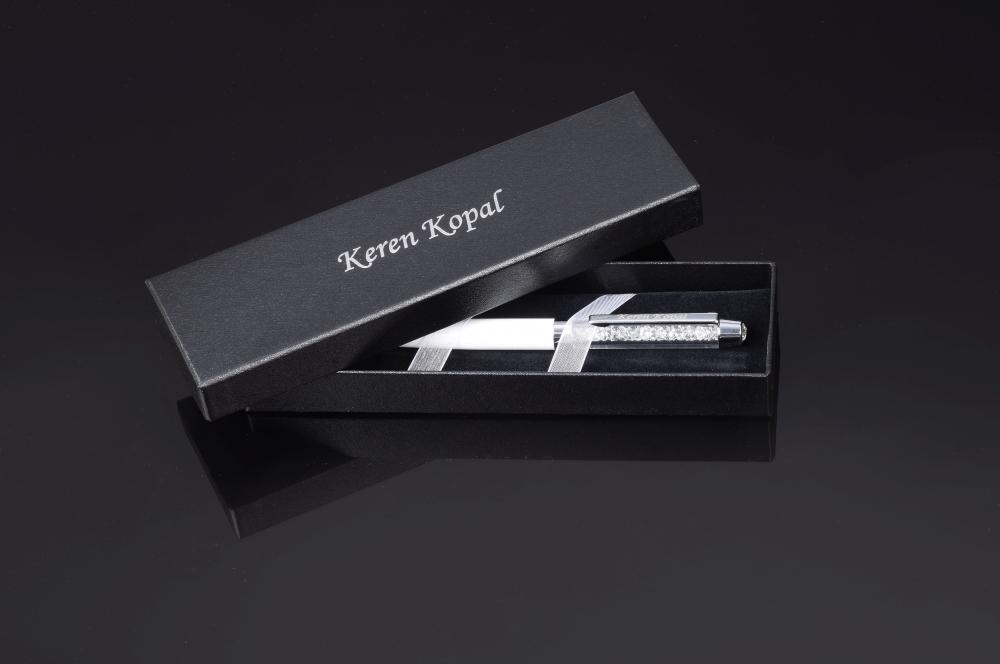 Elegant white pen adorned with sparkling Swarovski crystals, showcasing exquisite craftsmanship by Keren Kopal.