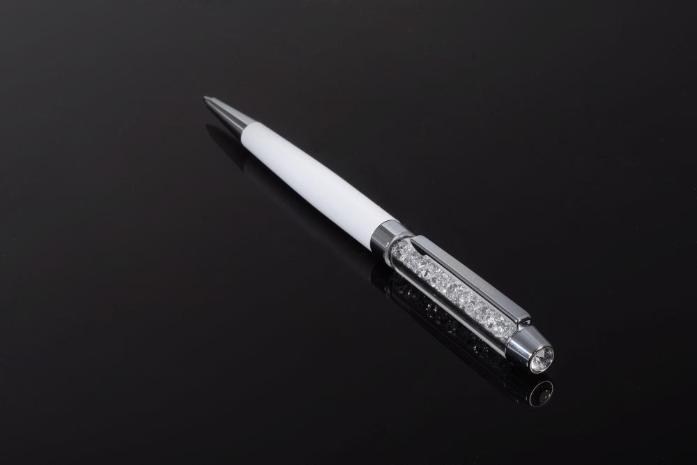 Elegant white pen adorned with sparkling Swarovski crystals, showcasing exquisite craftsmanship by Keren Kopal.