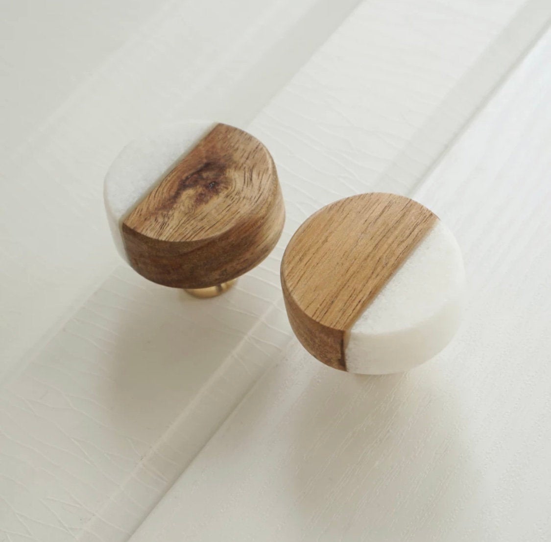 Handmade white stone and wood cabinet knobs showcasing modern design, perfect for various home decor styles.