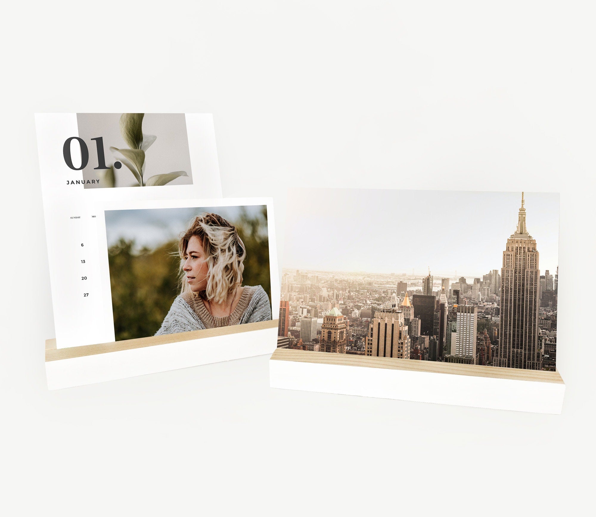 A stylish white wood bar holder displaying various photos and art prints, showcasing its versatility and elegant design.