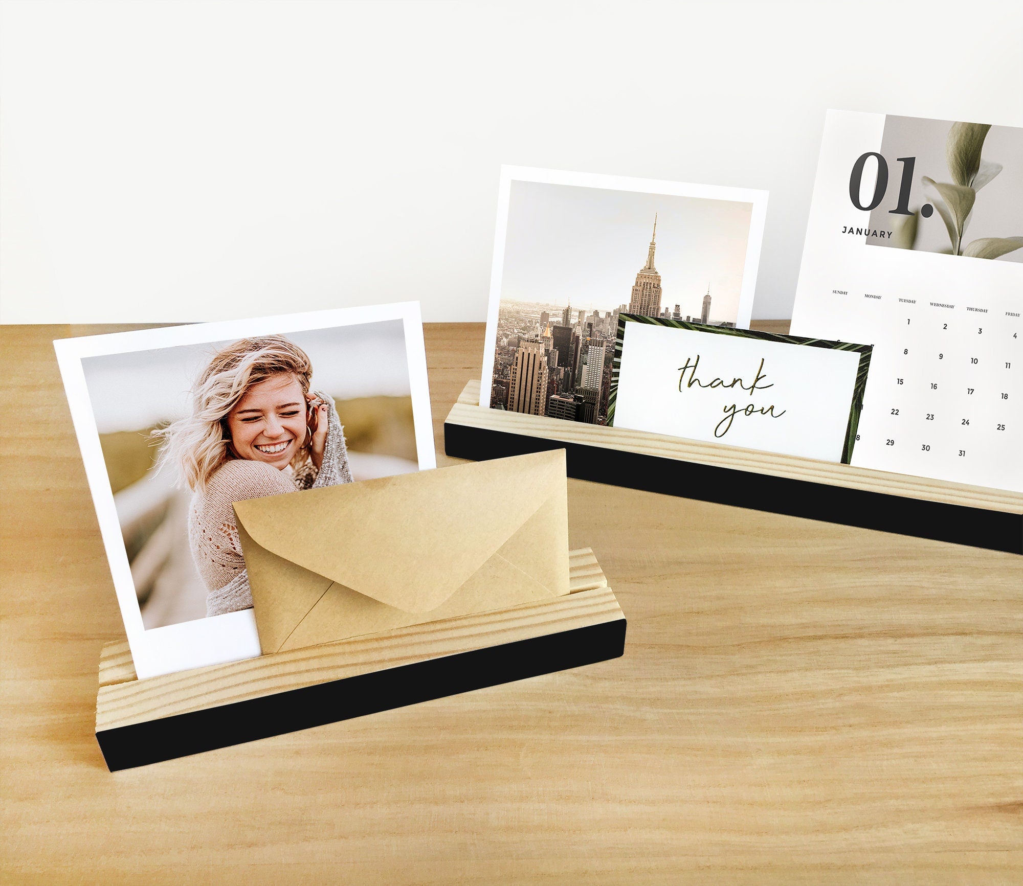 A stylish white wood bar holder displaying various photos and art prints, showcasing its versatility and elegant design.