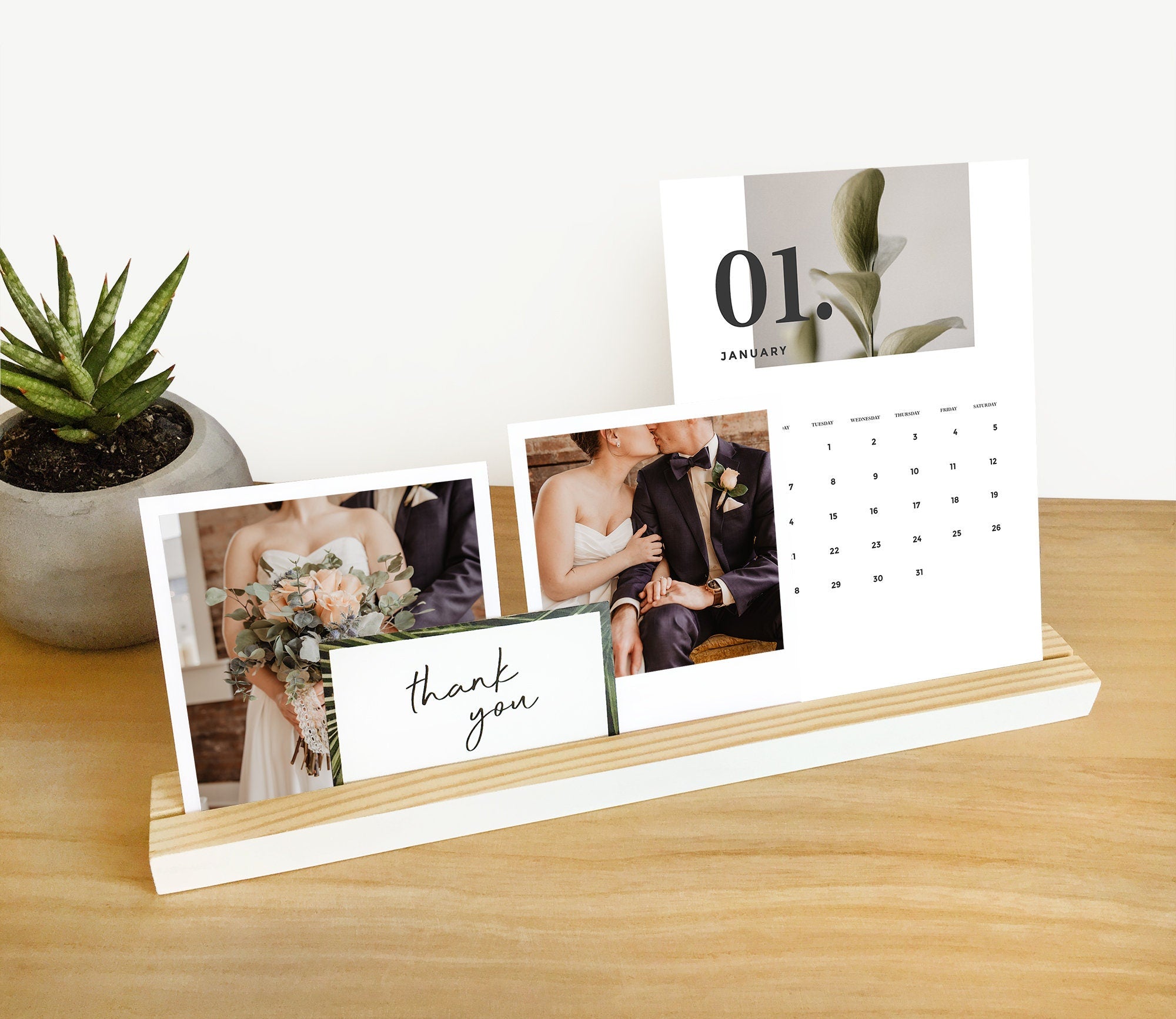 A stylish white wood photo ledge displaying various photos and art prints, showcasing its versatility and elegant design.