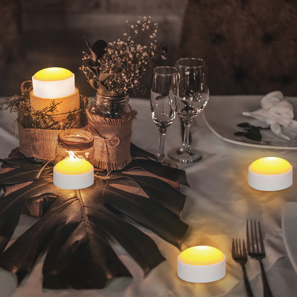 A set of four flameless LED tealight candles in warm yellow glow, perfect for creating ambiance without fire risk.