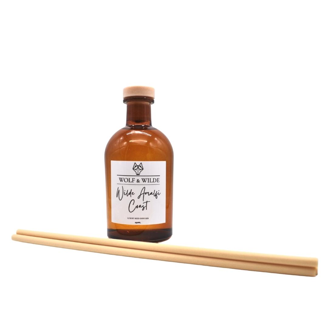 Wilde Amalfi Coast Apothecary Reed Diffuser in amber bottle with natural reeds, showcasing its elegant design and eco-friendly materials.