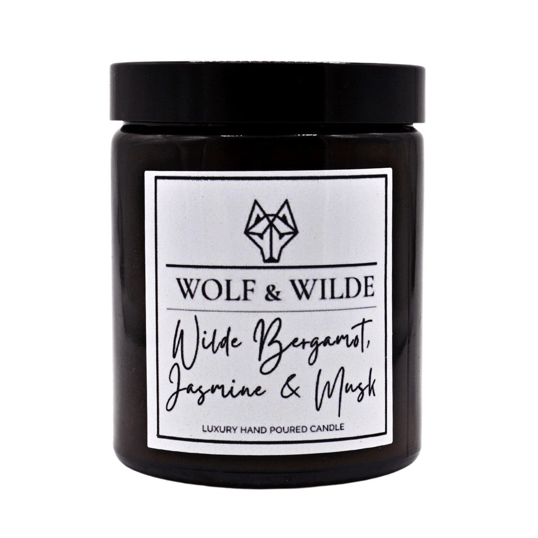 Wilde Bergamot, Jasmine & Musk Luxury Aromatherapy Scented Candle in an elegant glass jar, showcasing its rich color and luxurious design.