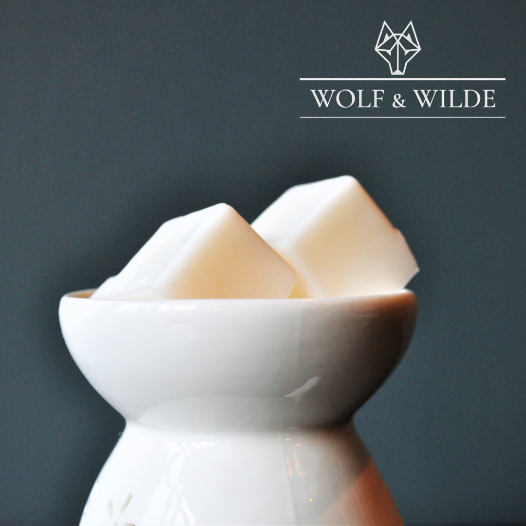 Wilde Enchantment Soy Wax Melts in a decorative package, showcasing a blend of floral and earthy scents.
