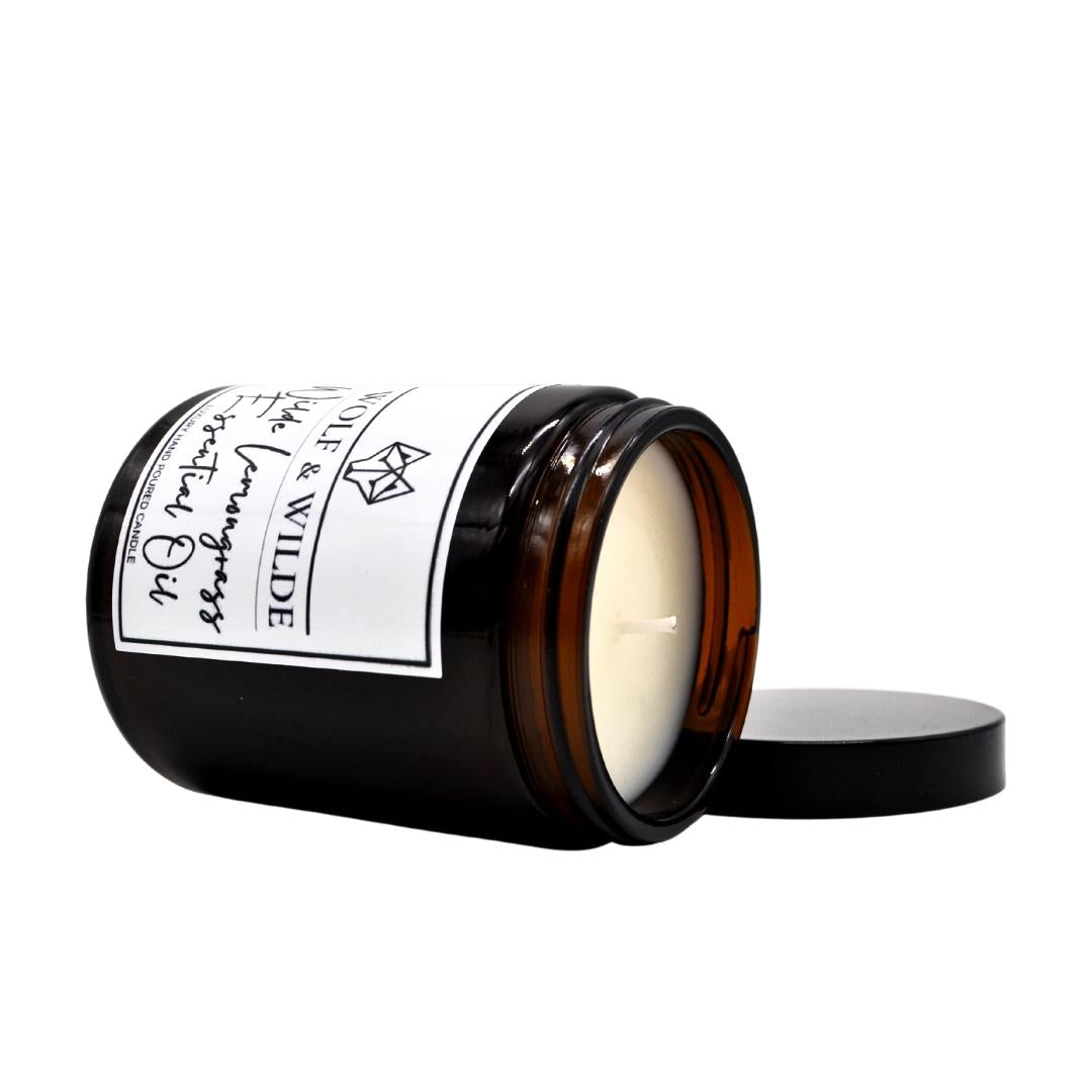 Wilde Lemongrass Essential Oil Luxury Aromatherapy Scented Candle in a stylish glass container, emitting a warm glow with a fresh lemongrass scent.