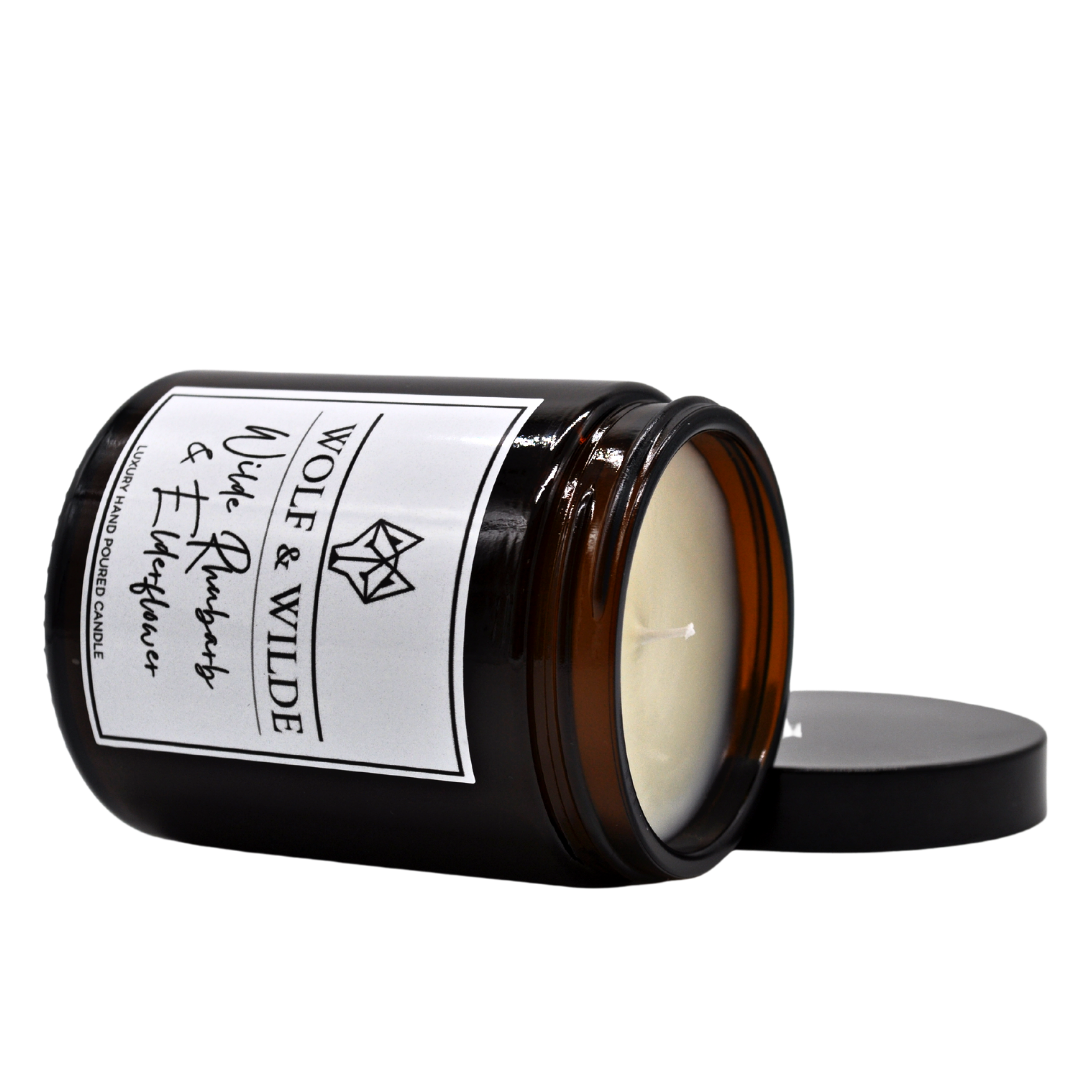 Wilde Rhubarb & Elderflower Luxury Handmade Scented Candle in an elegant glass jar with a warm glow.