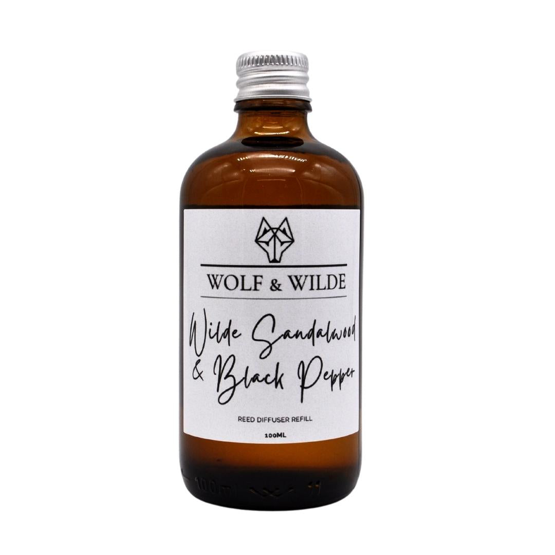 Wilde Sandalwood & Black Pepper luxury reed diffuser refill in an elegant amber glass bottle with an aluminium cap.